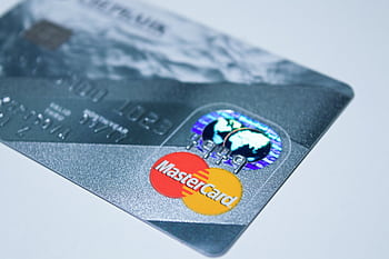 Detail shot of a MasterCard credit card, showing the chip and logo. HD wallpaper