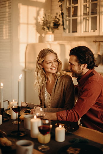 A serene romantic dinner setting with a couple enjoying candlelight, wine, and happiness. HD phone wallpaper