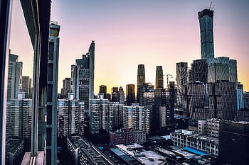 Captivating cityscape featuring modern skyscrapers against a twilight sky, perfect for urban-themed projects. HD wallpaper