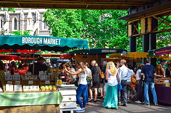 Lively scene at Borough Market in London, filled with people shopping and enjoying the atmosphere. HD wallpaper