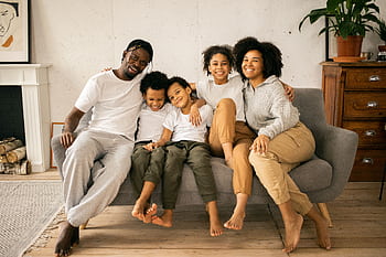 Enjoying quality time with family in a cozy living room setting. HD wallpaper