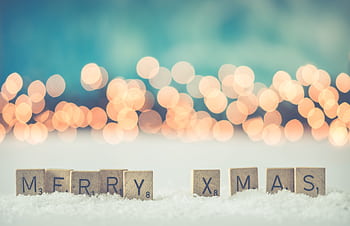 A decorative 'Merry Xmas' arrangement with festive bokeh lights, perfect for holiday themes. HD wallpaper