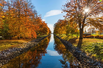 A que canal scene in Horten, Norway, showcasing vibrant autumn foliage and clear blue skies. HD wallpaper