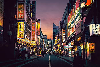 Explore the vibrant nightlife of Shibuya, Tokyo, showcasing neon-lit streets bustling with activity after sunset. HD wallpaper