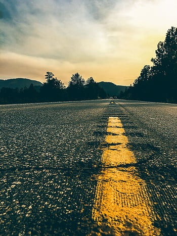 A striking road view in Golden, Colorado, captured at sunset with vivid colors and scenic mountains. HD phone wallpaper