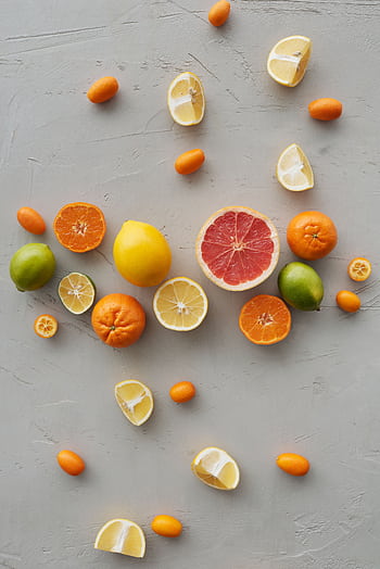 Flat lay of assorted citrus fruits slices, including lemon, lime, and grapefruit. HD phone wallpaper
