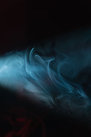 Moody abstract of swirling blue smoke with dark background and dramatic lighting. HD phone wallpaper