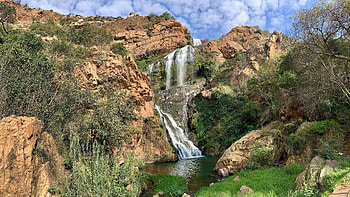 Landscape View Of Waterfalls Stream On Rocks Stones Lake Grass Bushes Under White Clouds Blue Sky Nature HD wallpaper