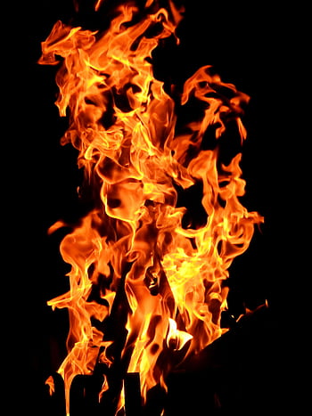 Close-up fiery blaze with vibrant orange flames creating a dynamic pattern against a dark backdrop. HD phone wallpaper