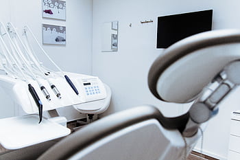 Bright dental office showcasing modern equipment and clean, sleek design. HD wallpaper