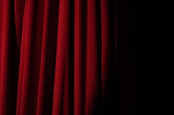 Elegant red velvet curtain with dramatic lighting perfect for theater themes. HD wallpaper