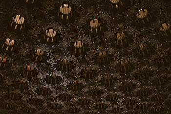 A detailed abstract ceiling with Islamic geometric patterns and dark textures. HD wallpaper
