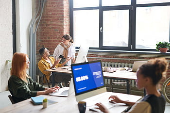 A diverse group of professionals collaborating in a creative modern office environment. HD wallpaper