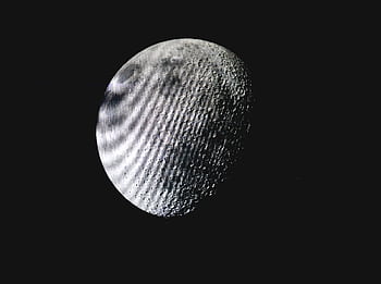 Captivating of the lunar surface with visible craters against a deep dark sky. HD wallpaper