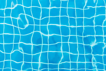 Top view of a swimming pool with vibrant blue water and tile patterns. HD wallpaper