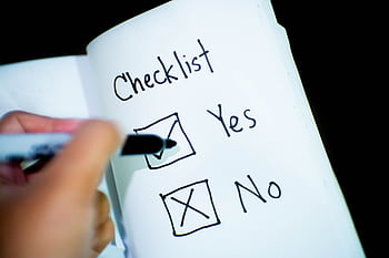 A notebook featuring a checklist with a marked 'Yes' box, captured in a close-up shot. HD wallpaper