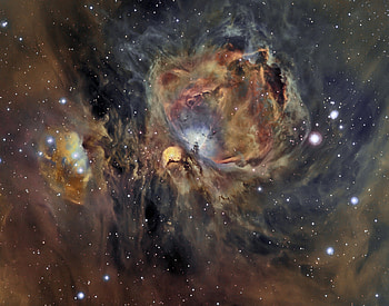 The Nebula's glowing gas surrounds hot young stars at the edge of an immense interstellar molecular HD wallpaper