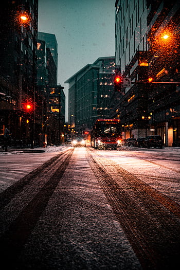 City street in Denver, CO, covered in snow at night with glowing streetlights and traffic. HD phone wallpaper