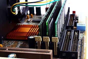 Detailed view of computer motherboard featuring RAM, chipset, and wiring. HD wallpaper