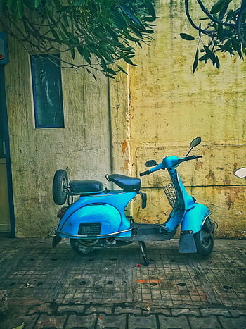 A classic blue scooter parked in an alley in Bengaluru, India, exuding a nostalgic and urban vibe. HD phone wallpaper