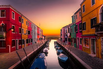 Vibrant facades along Burano's canal with boats at serene sunset. Perfect travel snapshot. HD wallpaper