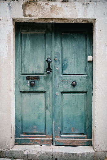 Close-up of a weathered turquoise door with rustic details in Dubrovnik, Croatia. HD phone wallpaper