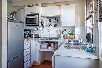 Sophisticated kitchen interior with modern appliances, wooden accents, and functional design. HD wallpaper