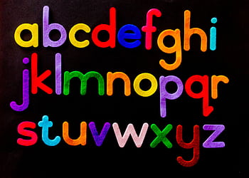 Vibrant alphabet letters arranged against a dark background for educational use. HD wallpaper