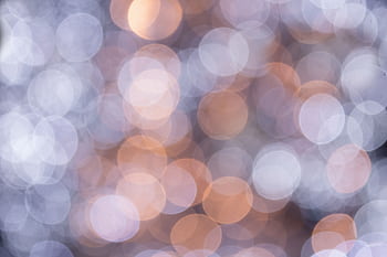 A soft-focus abstract featuring circular bokeh lights in warm and cool tones. HD wallpaper