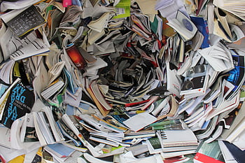 A whirlwind of books and papers creating a chaotic visual. Ideal for concepts of disorder or information overload. HD wallpaper