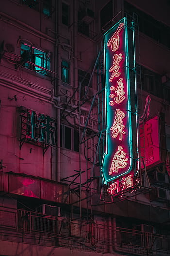 Neon signs illuminate the night in Kowloon, Hong Kong, creating a vibrant and colorful urban scene. HD phone wallpaper