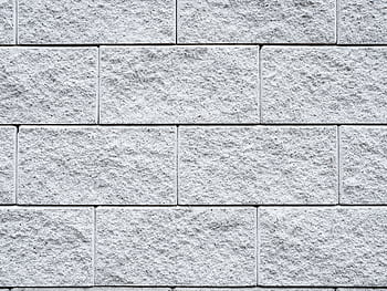Detailed texture of a white brick wall, perfect for backgrounds and design projects. HD wallpaper