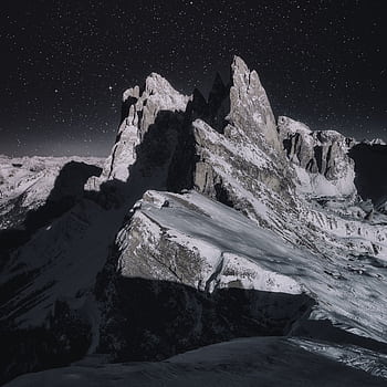 Dramatic night view of snow-capped peaks in the Italian Alps under a starry sky. HD phone wallpaper