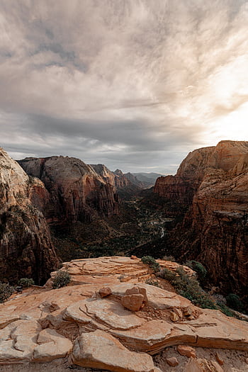 Capture of the dramatic Zion National Park cliffs during a tranquil sunset with a cloudy sky. HD phone wallpaper