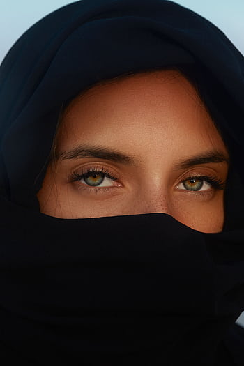 Close-up portrait of a woman with heterochromia wearing a hijab highlighting her unique eyes. HD phone wallpaper