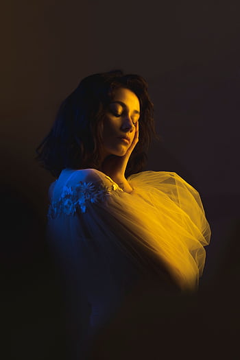 Artistic portrait of a woman in soft, dramatic lighting with a contemplative pose. HD phone wallpaper