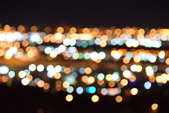 A mesmerizing view of blurred city lights creating a colorful bokeh effect at night. HD wallpaper