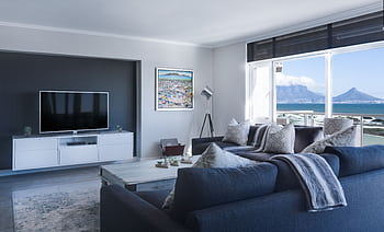 Stylish living room with a view of Table Mountain, blending modern design with natural beauty. HD wallpaper