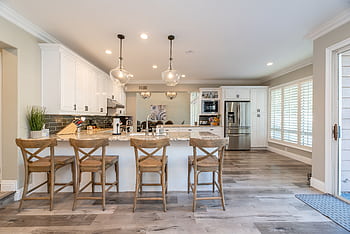 Bright and spacious kitchen interior featuring bar stools and modern design elements. HD wallpaper