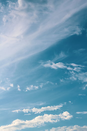 Peaceful sky with wispy clouds drifting in the blue, evoking serenity and calmness. HD phone wallpaper