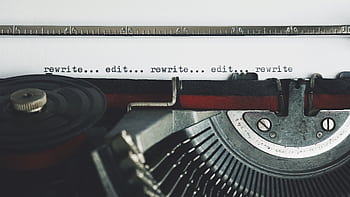Classic typewriter with text 'rewrite... edit...' on paper. HD wallpaper