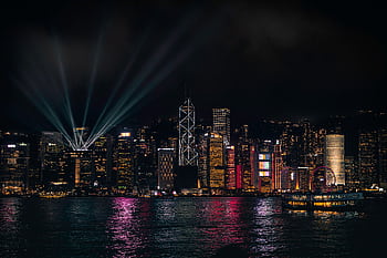 Stunning night view of Hong Kong skyline with vibrant lights reflecting on the water. HD wallpaper