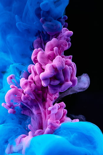 Stunning capture of colorful ink diffusing in water, showcasing vibrant blues and purples. HD phone wallpaper