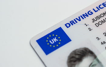 Detailed of a UK driving license showcasing EU flag and identity features. HD wallpaper
