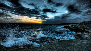 rough sea under dark clouds sky rocks ocean waves splash during sunset Nature HD wallpaper