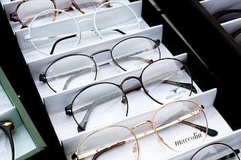 Close-up of assorted eyeglasses showcased in an orderly fashion for selection. HD wallpaper