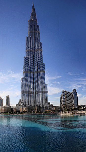 Dubai Skyline, Khalifa Tower, Clouds and water, Architectural marvel HD phone wallpaper