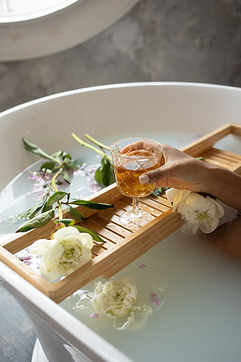 Serene bathtub scene with flowers, aromatherapy, and a drink. HD phone wallpaper