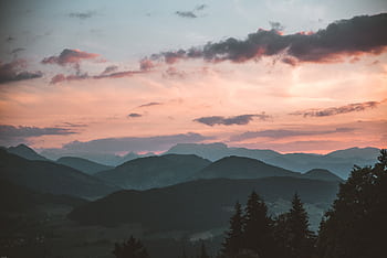 Tranquil view of Brixen im Thale mountains at sunset, capturing serene natural beauty. HD wallpaper