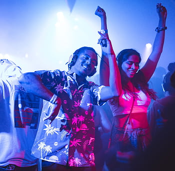 Vibrant nightclub scene with people dancing energetically to music. HD wallpaper
